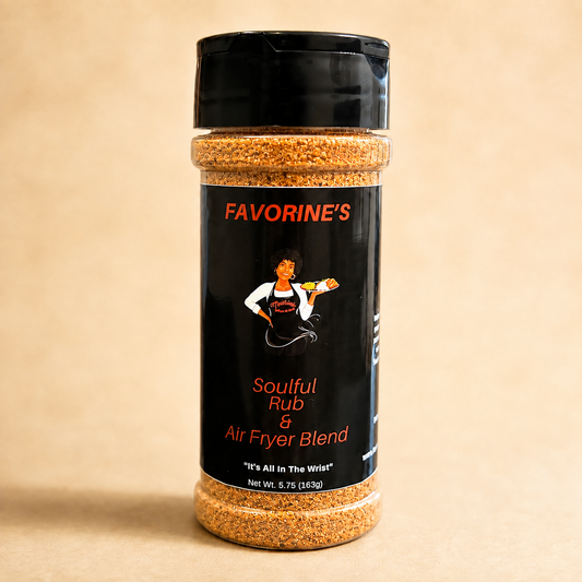 A bottle of FAVORINE'S Soulful Rub & Air Fryer Blend seasoning, featuring a black shaker cap and a black label with red and white text and graphics, set against a warm beige background.